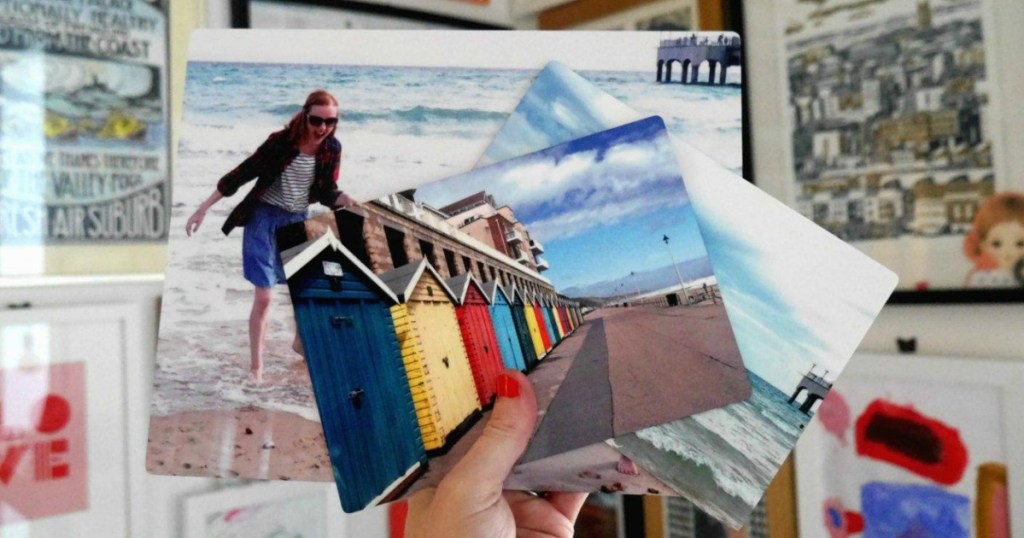 Vacation photo prints in hand