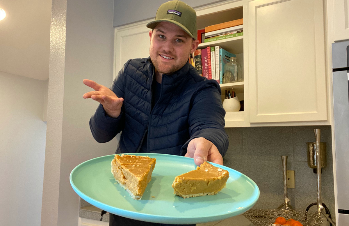 man holding plate of pumpkin pies