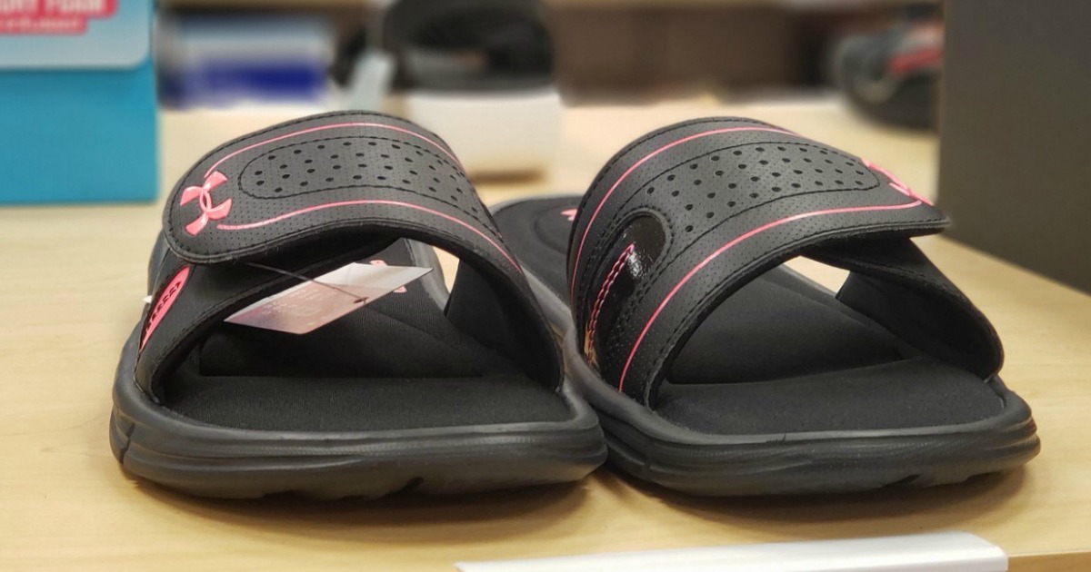 Under Armour brand slide sandals for girls on display in-store
