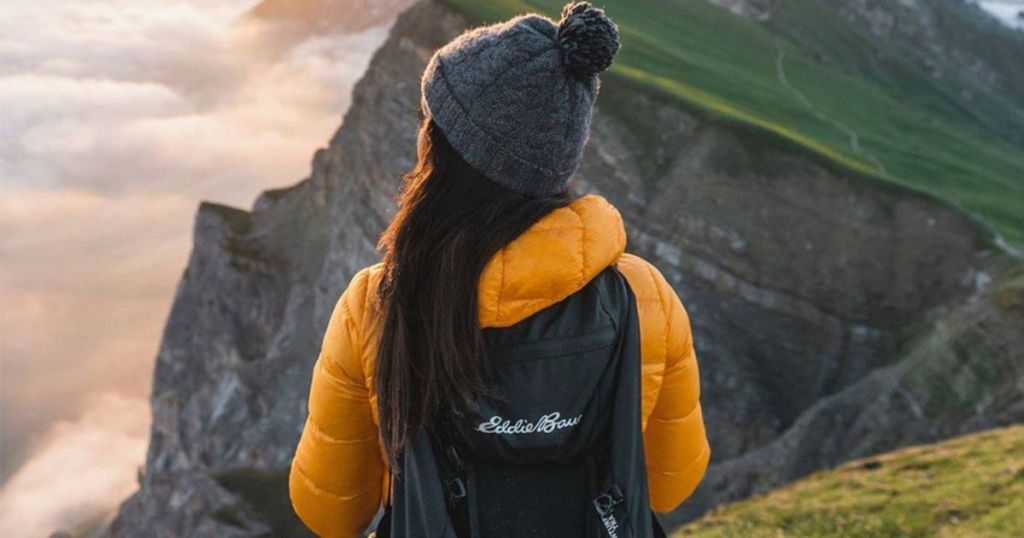 Women with eddie bauer backpack and yellow jacket