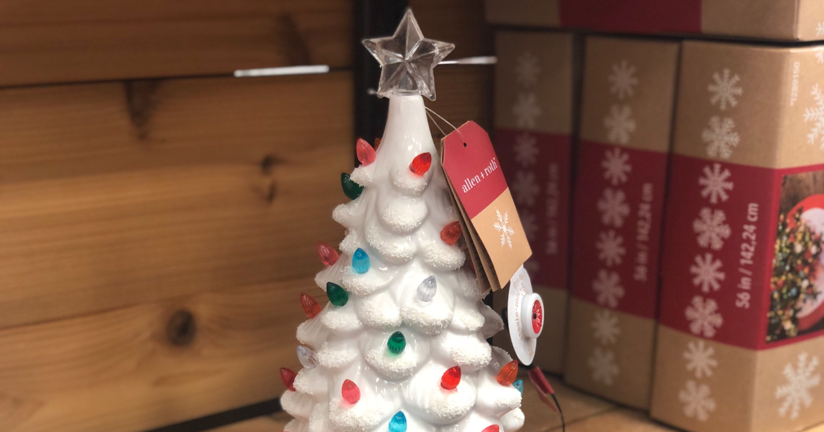 white ceramic tree with lights sitting on shelf in store