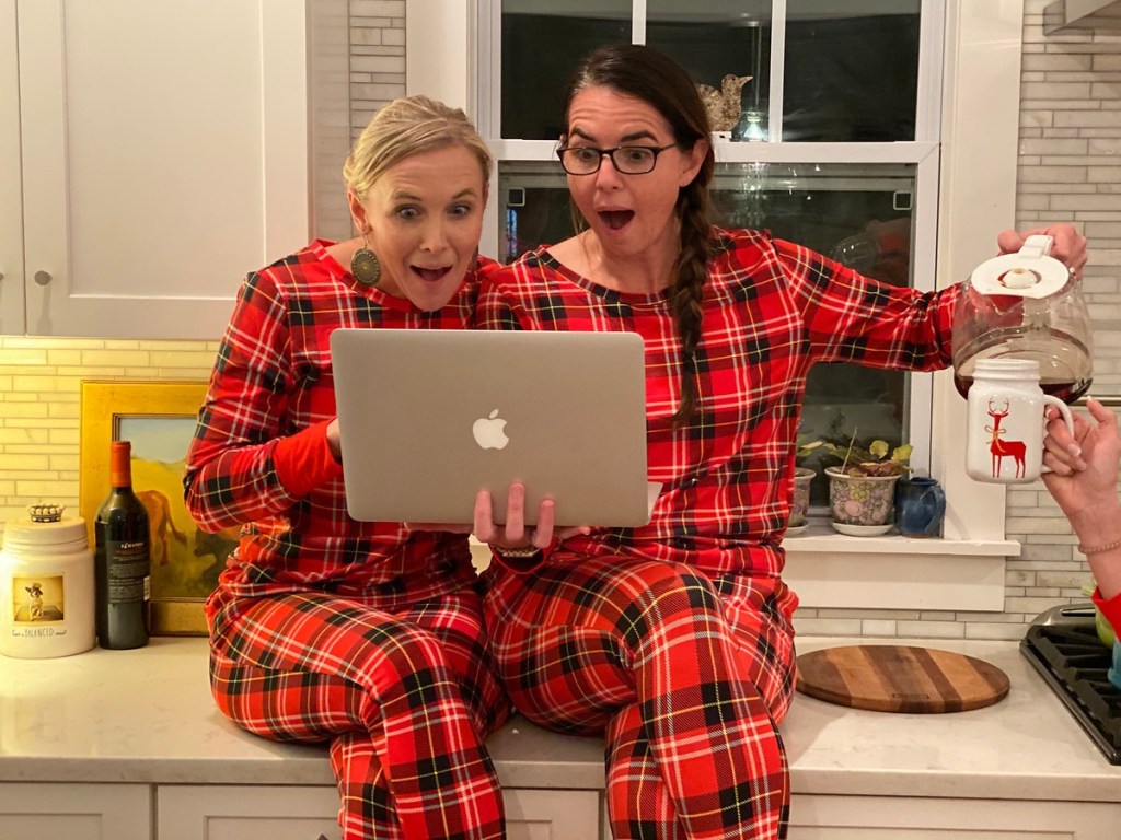 women with laptop in plaid pajamas