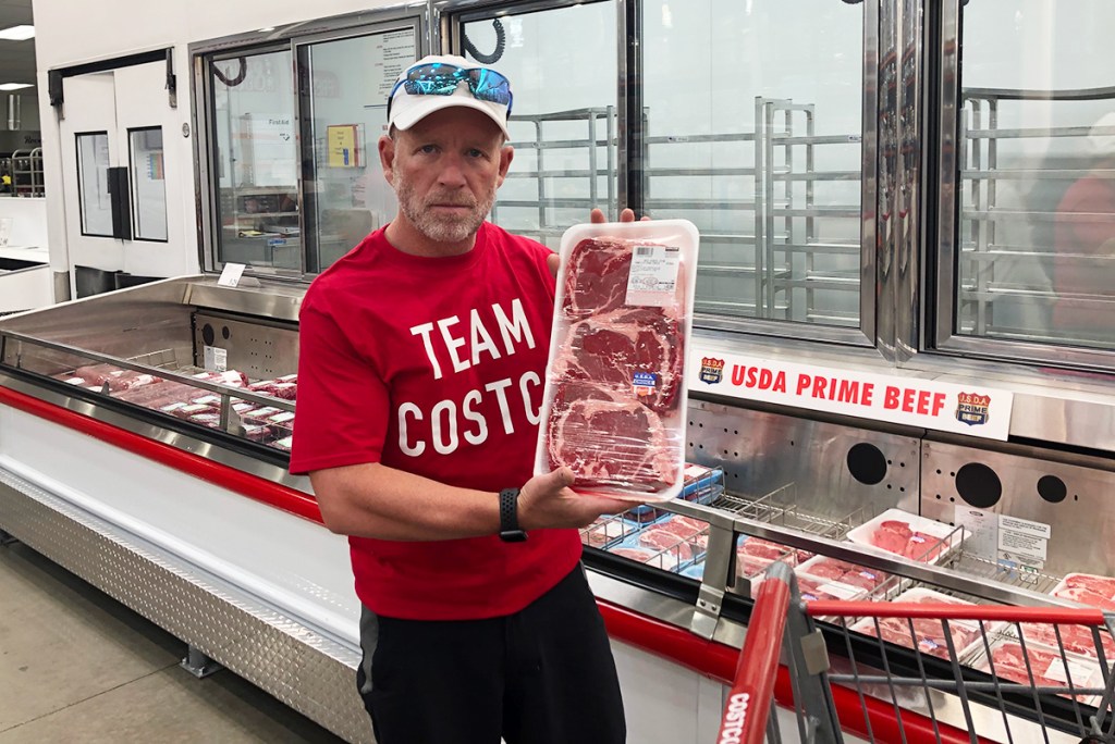 Bruce holding up bulk meat package at Costco