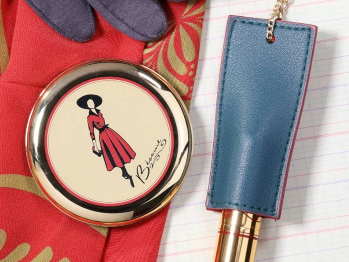 scarf, powder compact and lipstick on table