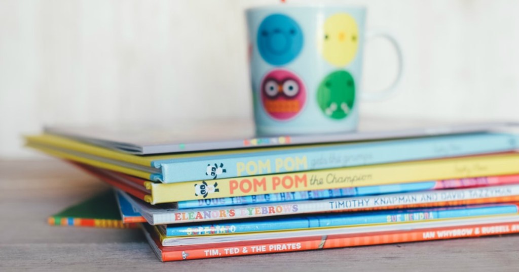 stack of children's book with mug on top