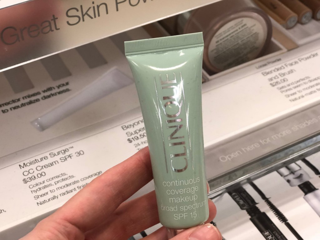 hand holding clinique coverage coverage makeup in store