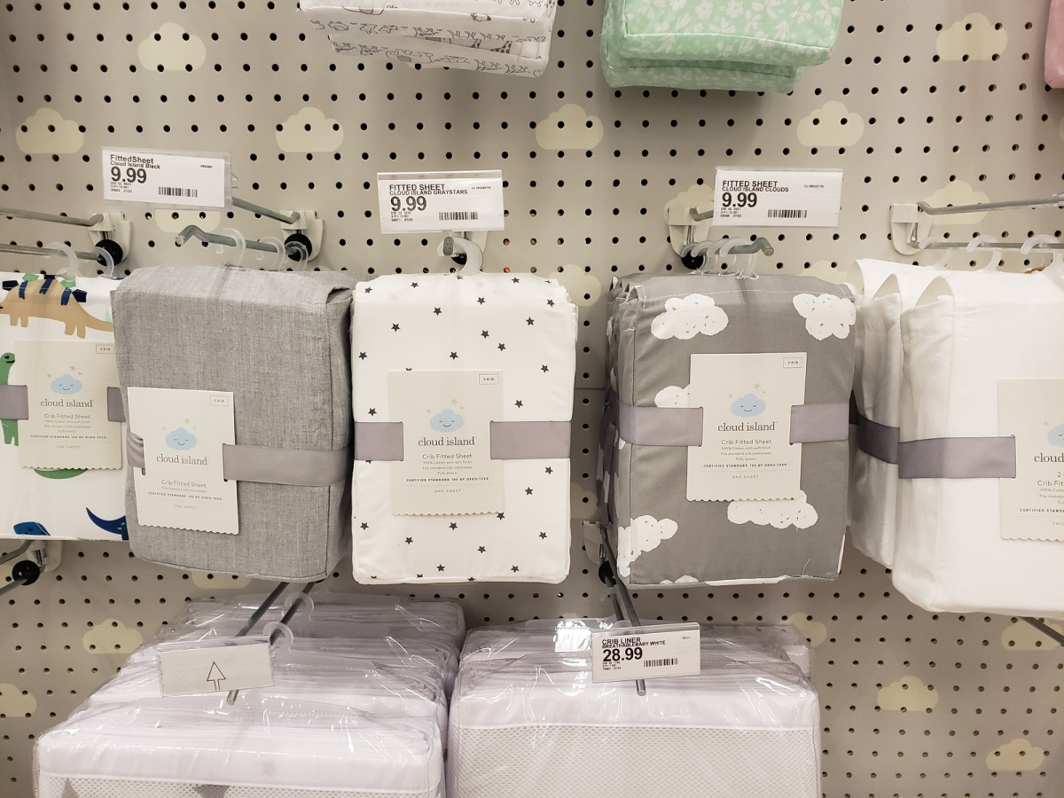 cloud island baby sheets hanging in store