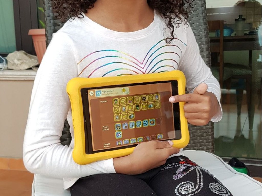 little girl showing tablet to camera