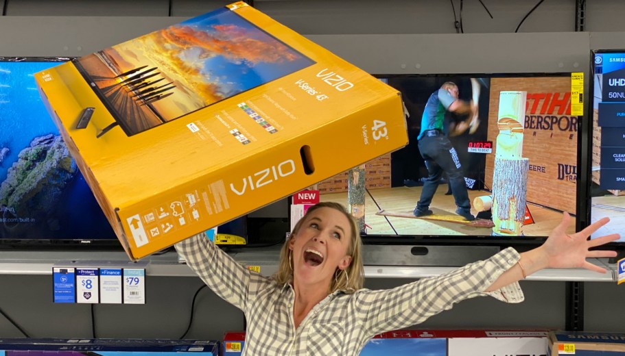 woman holding tv box in store