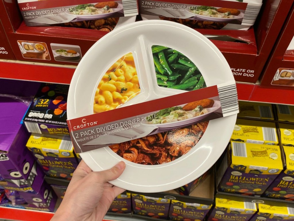 hand holding package of plastic plates by store display