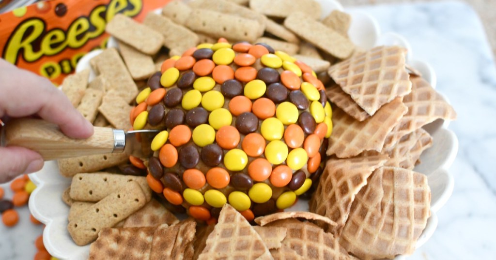 cutting into a Reese's peanut butter ball
