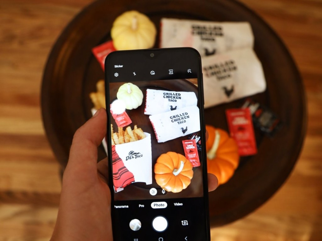 taking a photo of tacos and pumpkins