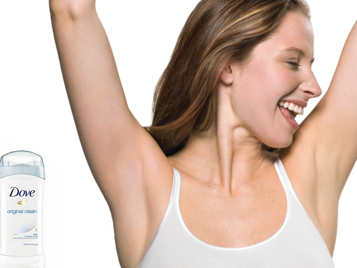 woman holding arms up next to deodorant