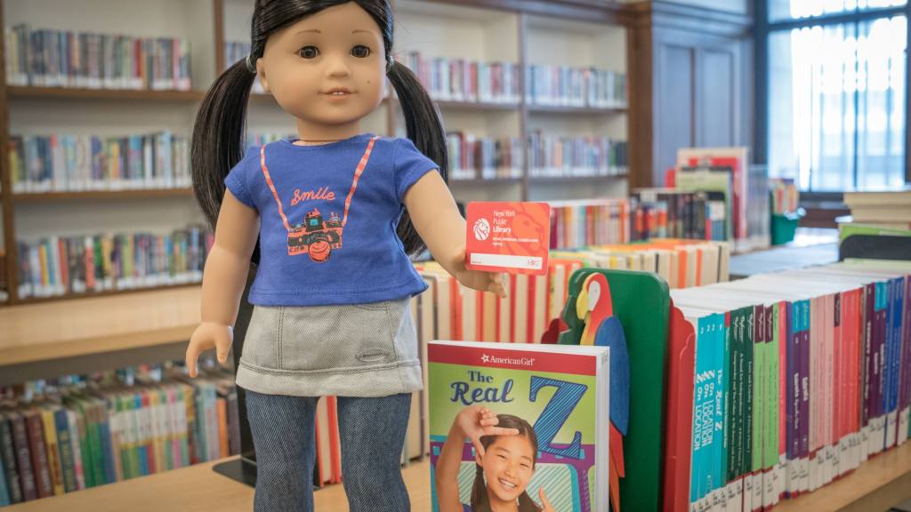 american girl doll in library