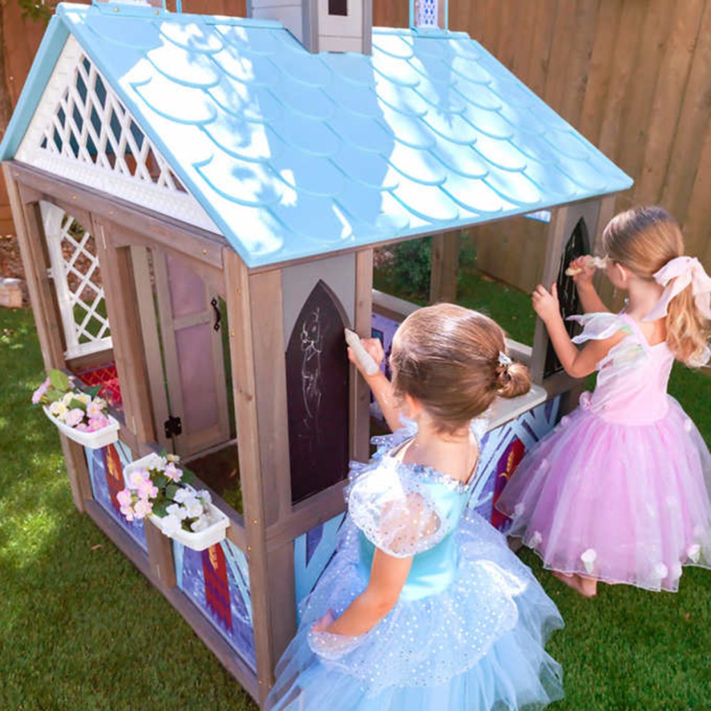 two girls playing with Frozen Arendelle Playhouse