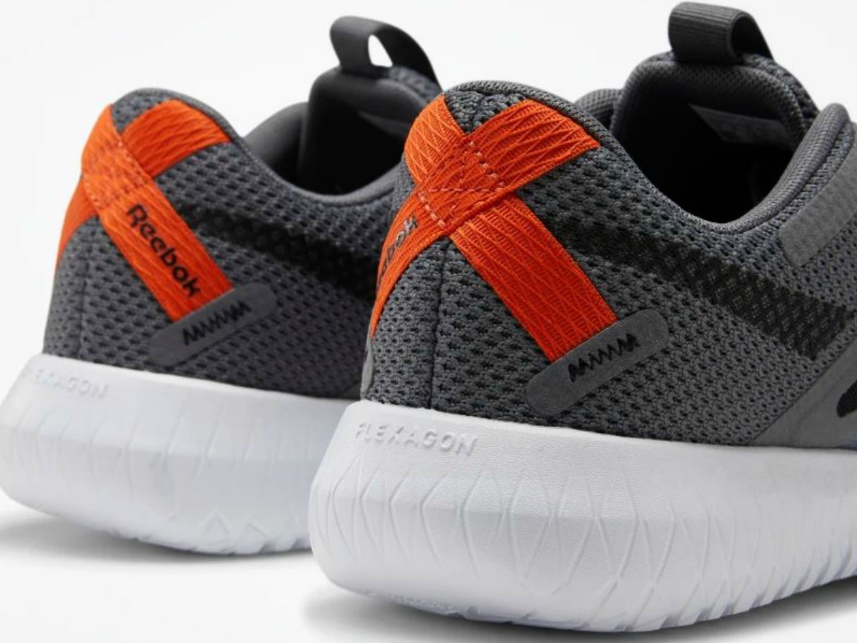 pair of back of shoes that are grey and orange