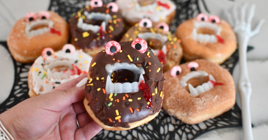 holding a vampire donut halloween treat- halloween party food 