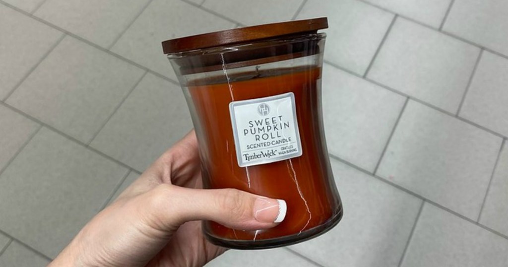 hand holding orange candle in store