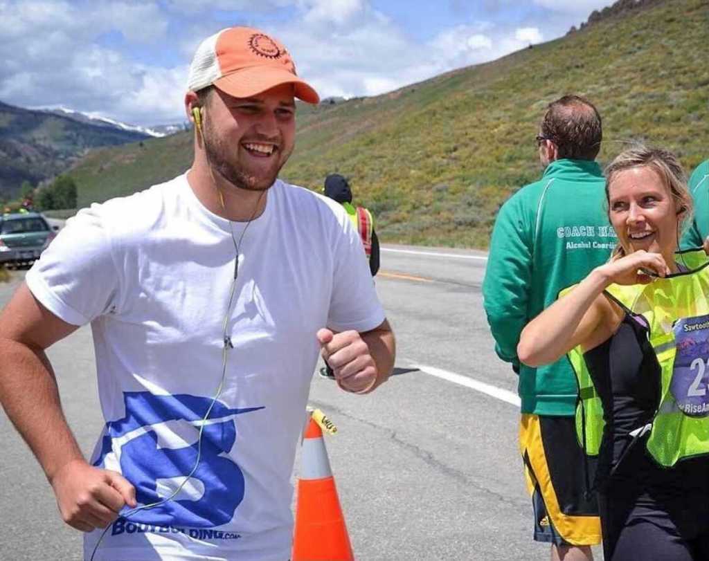 man running in marathon next to woman