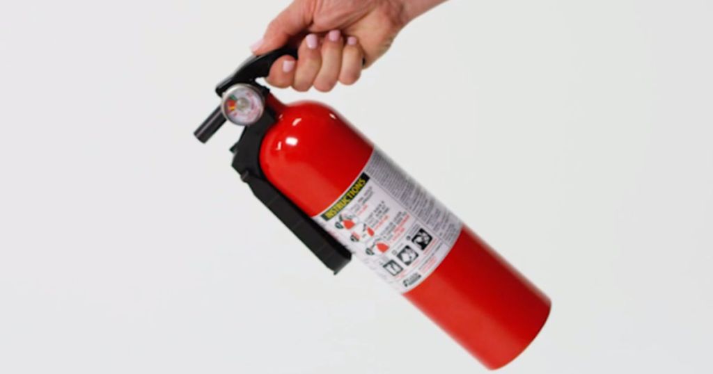 hand holding Kidde fire extinguisher