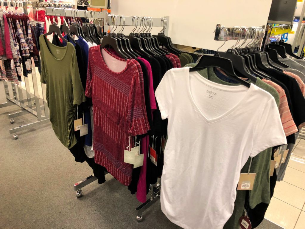 kohl's aglow maternity shirts on hangers in the store