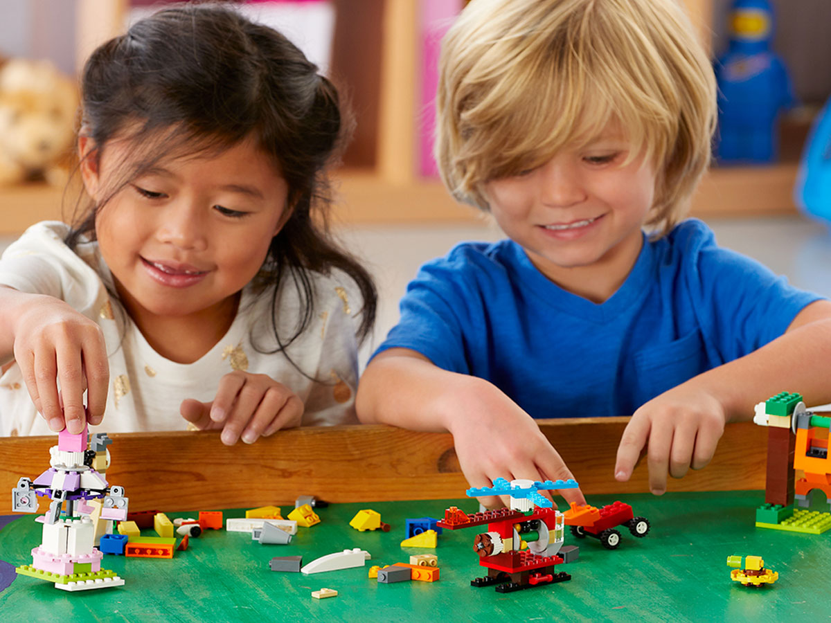 kids playing with LEGO classic bricks and gears