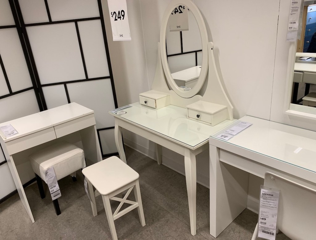 white vanity desk with oval mirror on top in ikea store