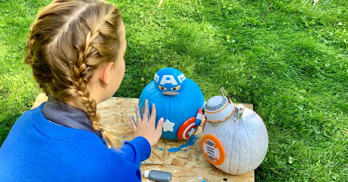 girl assembling no-carve pumpkin kits