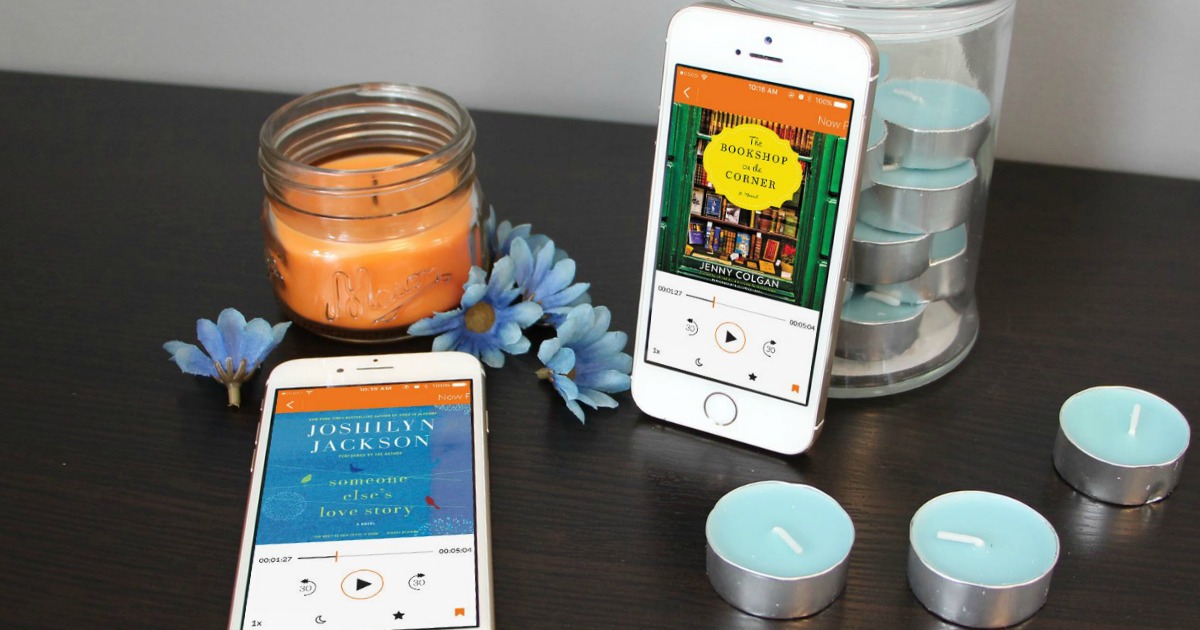 phones showing Audiobooks app on table with candles and flowers