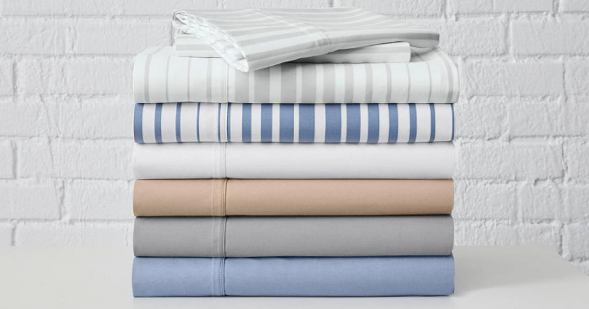 pile of sheet sets on shelf with brick wall home depot