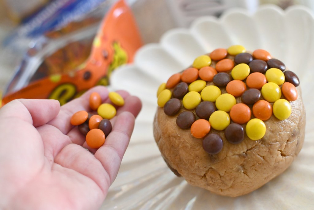 placing Reese's Pieces on a cheese ball