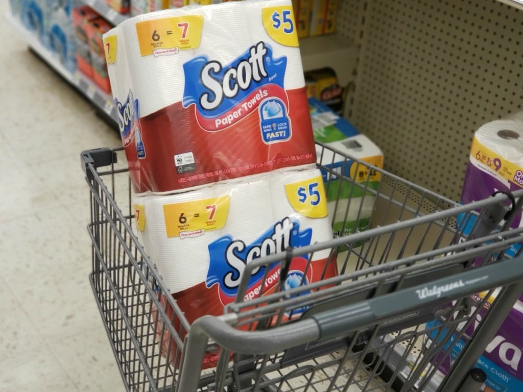 grocery cart with paper towels in it