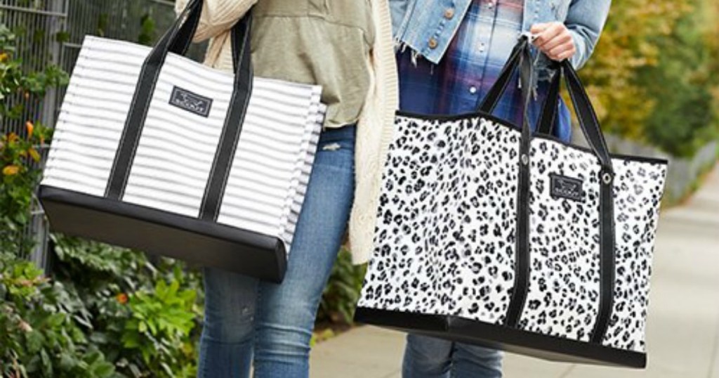 two women carrying black and white SCOUT tote bags