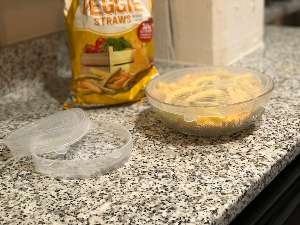 silicone stretch lids on counter with snacks in bowl