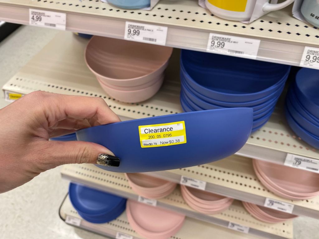 hand holding blue bowl on store shelf