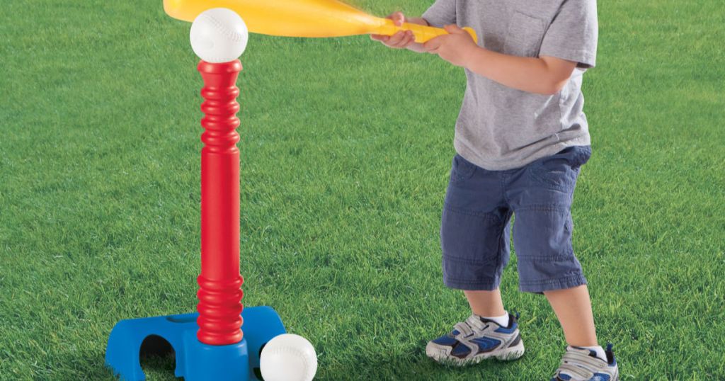 child hitting baseball off of tee