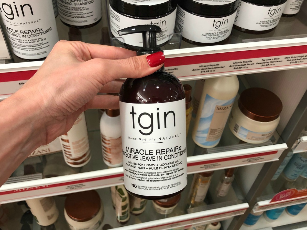 tgin leave-in conditioner in bottle in hand in store