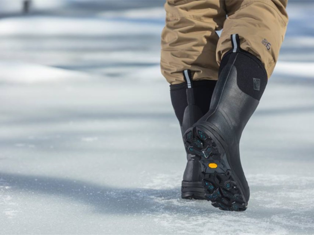 man waling through snow wearing the original muck boots