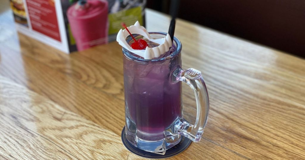 purple drink with cherry and vampire fangs in drink