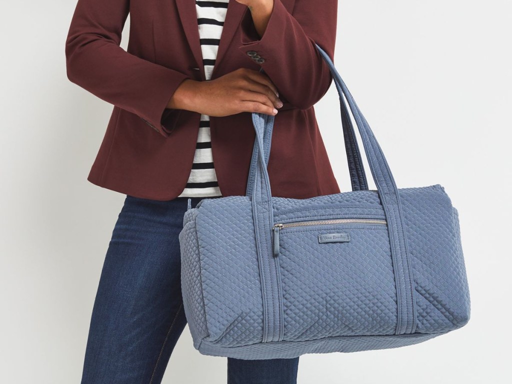 woman posing with vera bradley duffel bag