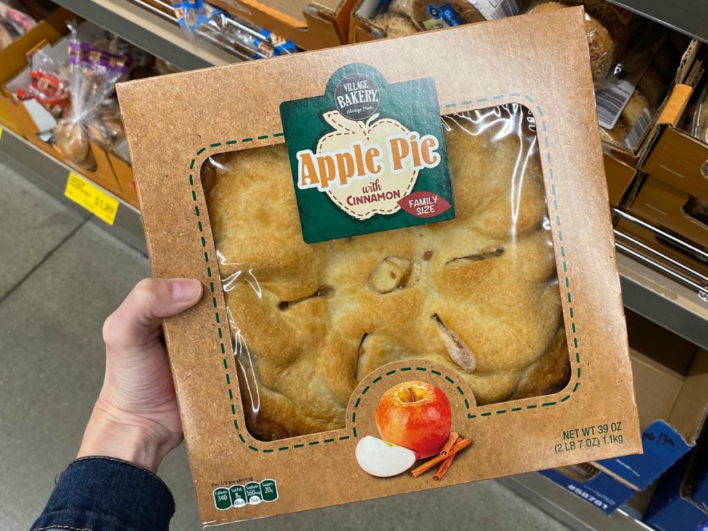 hand holding box with apple pie in store