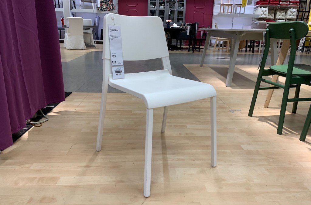 single white chair sitting on wood floor in IKEA store