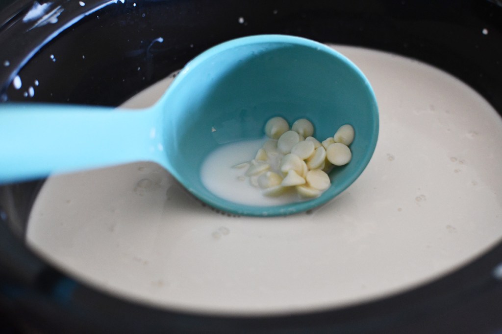 adding white chocolate chips to milk in crock pot