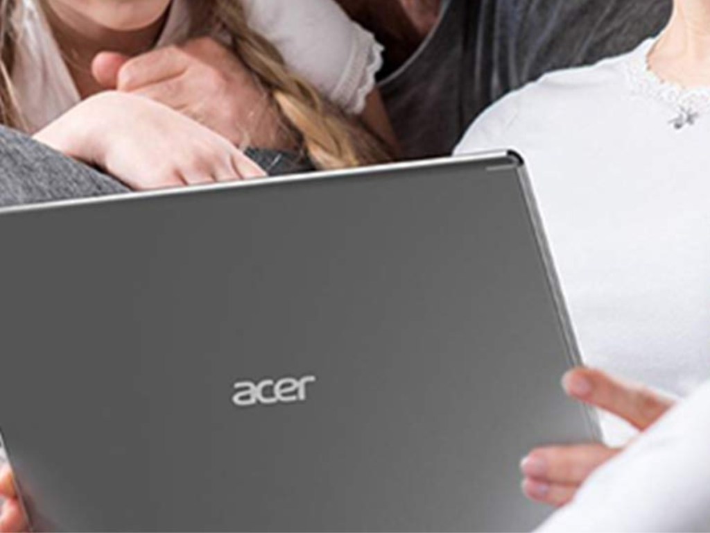 close up of Acer Aspire 5 Slim Laptop in women's hands with family around her
