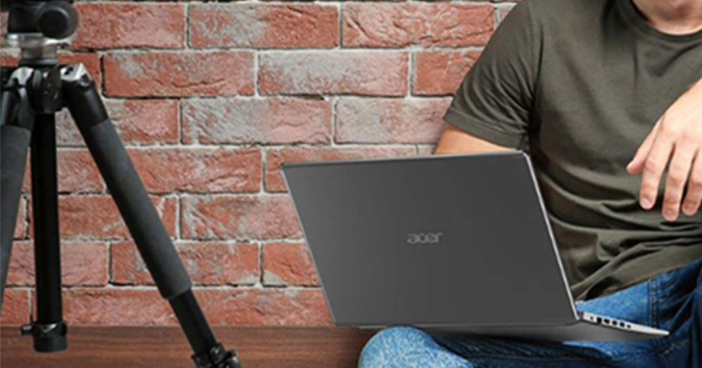 man sitting on brick wall with Acer Aspire 5 Slim Laptop