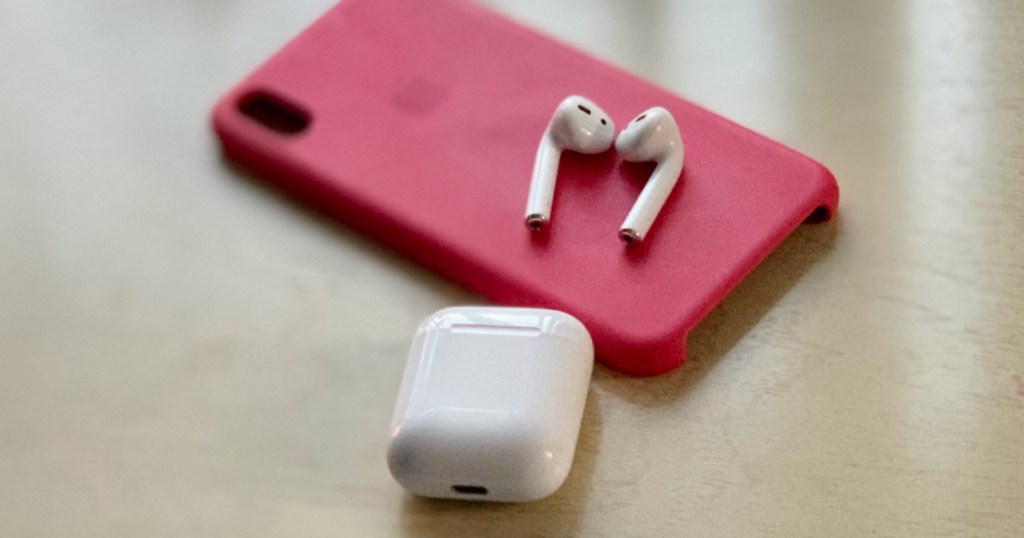 Apple Airpods lying on top of iPhone