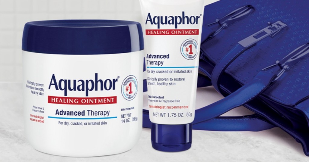 Aquaphor Healing Ointment Multipack next to purse