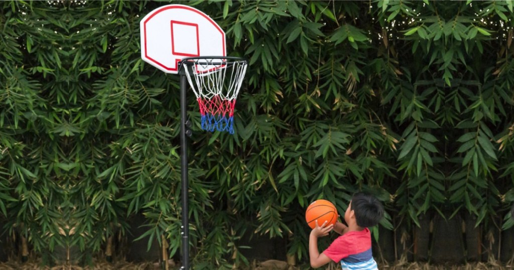kid playing at Basketball Hoop