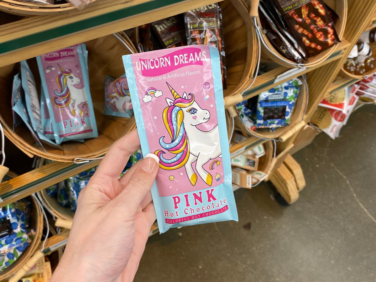 Hand holding Unicorn Dreams Pink Hot Chocolate 1.25 oz at World Market