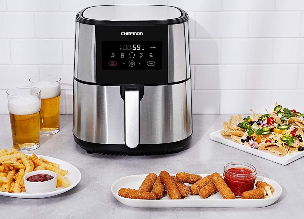 air fryer with food around it